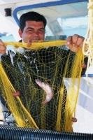 Fisherman fixing his fishing net