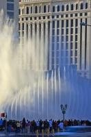 The orchestrated fountains of the Bellagio Hotel and Casino overshadows the architecture of Caesars Palace right next door in Las Vegas. By day the show looks somewhat different as the streams of water are highlighted by the shining sun.