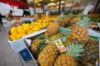 A market stall at the Kensington Market in downtown Toronto, Ontario, displays a long row of a variety of fresh fruit.