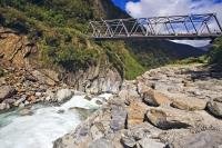A bridge along State Highway 6 crosses the Gates of Haast, a series of rapids along the Haast River in Mt Aspiring National Park, West Coast, South Island, New Zealand.