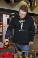 A skilled artist giving a demonstration of glass blowing at the Lincoln City Glass Center in Oregon, USA.