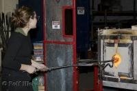 A woman demonstrating glass blowing techniques at the Lincoln City Glas Center in Oregon, USA.