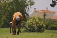 Teeing up your golf ball is essential before hitting your drive like this man is doing at the Oliva Nova Golf Course in Valencia, Spain in Europe.