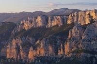 The rugged cliffs of the Gorges du Verdon in the Alpes de Haute in the Provence, France turn a beautiful shade of pink and yellow as the sun glistens off them at sunset.