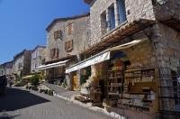 The sun shines down on the shops in the village of Gourdon in Provence, France in Europe.