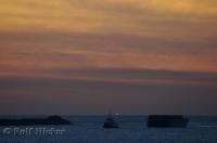 A tug and barge navigate the entrance to Grays Harbor in Westport, Washington, USA.