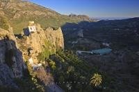 Shade closes in over the valley landscape and the Castle of Guadalest in the Province of Alicante in Comunidad Valenciana, Spain in Europe.