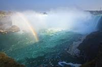 A rainbow appearing below the Horseshoe Falls in Ontario, seems to rise out of the surface of the Niagara River.