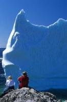 A large iceberg which is beached near the village of Twillingate in Newfoundland is viewed by tourists from the shore.