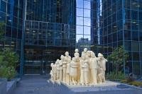 A unique sculpture called the Illuminated Crowd adorns the exterior of the BNP Tower - Laurentian Bank Tower in Montreal, Quebec in Canada.