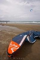 The power kite is a main piece of equipment required for kite surfing and for taking to the sky like the kite surfer in the background along the sandy beach in Orewa, New Zealand.
