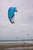 Many people find kite surfing on the beach in Orewa on the North Island of New Zealand the perfect way to spend their holiday.