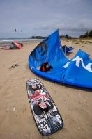 Kiteboarding gear has been upgraded considerably over the years as this picture shows newer equipment laying on the beach in Orewa, New Zealand.