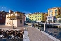 The waterfront along Garda Lake in the town of Torbole, Italy is picturesque as the colorful buildings boldly stand out as you walk along the lakeshore.