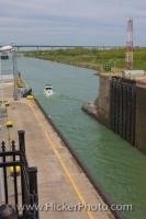 A small leisure boat makes its way through Lock 3 of the Welland Canal System at the St Catharines Museum in Ontario, Canada.