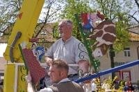 This sign is being attached to the Maibaum by a local businessman in Putzbrunn, Germany.