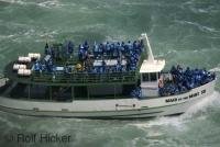 The blue jacketed passengers of the Maid of the Mist enroute to see the world famous Niagara Falls in Ontario, Canada.