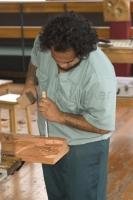 An artist is deep in concentration as he chisels a carving at the New Zealand Maori Arts and Crafts Institute in Rotorua, New Zealand.