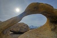Granite rock sculpted by nature into a curved arch formation, Mobius Arch offers framed views towards the snowcapped Sierra Nevada Mountains from the Alabama Hills Recreation Area. The position of the sun was an added bonus on this particular day.