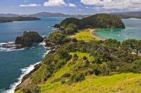 Lush greenery separates the two different looking sides along the coastline of Motuarohia (Roberton) Island on the North Island of NZ.