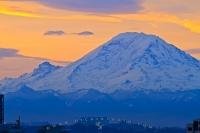 The highest mountain in the Cascade Range of Washington State, Mount Rainier rises to a height of 4392 metres. When seen from the east at sunrise, its snow covered slopes contrast dramatically against a cheerfully coloured sky.