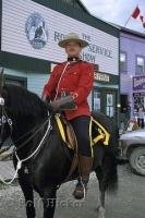 A RCMP Mountie dressed in full uniform on horseback at the Klondike Gold Rush National Historic Site, Dawson City, Yukon Territory, Canada.