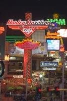 The famous Las Vegas Strip is lit up by many neon signs, advertising the endless possibilities for entertainment and attractions available and vying eagerly for the attention of passersby.