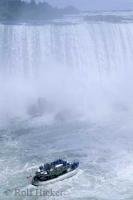 The Maid of the Mist boat edges toward the forceful Niagara Falls during one of the daily tours to the popular tourist attraction.
