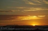 The last golden rays of the sunset brighten the sky while dimming the ocean at Ruby Beach on the Olympic Peninsula of Washington.