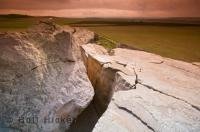 An interesting feature left by receding ice from ancient glaciers, the Okotoks Erratic sits in a flat field and is a historic site in Alberta, Canada.