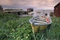 An old fishing boat rests on the shores in the L'Anse aux Meadows fishing village in Newfoundland, Canada.