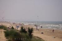 Kite surfers mix in with the sun tanners along the beach in Oliva Nova in Valencia, Spain in Europe.