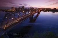 The beautiful sunset reflections on the Ottawa River looking across to Hull in Quebec from Nepean Point, Ontario.