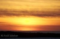 A stunning sunset over the Pacific Ocean seen from Grays Harbor in Washington, USA.