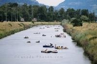 The locals taking a leisurely tube ride down the Penticton River Channel during the summer in British Columbia, Canada.