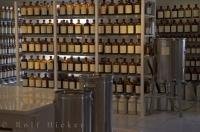 Hundreds of perfume bottles stacked on shelves in the laboratory of Fragonard Parfumeur in Grasse in Provence, France.