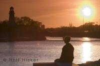 A beautiful sunset at Port Credit in Mississauga, Ontario with the lighthouse and on the banks of the Credit River.