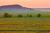 A medley of colours, vivid pinks and fresh greens, adorn the scenery of the Saskatchewan prairie which is punctuated by the Big Muddy Badlands.
