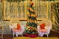 A beautiful Christmas tree scene on a verandah bordered by elegant wreaths and delicatly draping lights. This delightful Christmas Scene was taken in 2006 at a house in Pukeuri in Otago on the East Coast of the South Island of New Zealand.