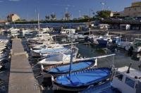 Fishing boats line the docks at the marina in Sausset Les Pins in the Provence, France in Europe.