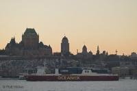 Photo of Quebec City in winter with a large ship breaking the ice of the St. Lawrence River.