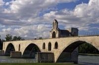The Pont St Benezet and the Chapelle St Nicolas span across the Rhone River which flows through Avignon, France in Europe.