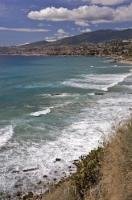 The waters of the Riviera di Ponente lap the shores of the bustling city of San Remo a popular vacation destination in Italy.