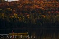 Canoeing Rock Lake in Algonquin Provincial Park in Ontario, Canada is at its best during Autumn when the sunset lighting reflects off the water and the colorful forest.