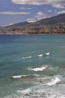 The azur waters of the Riviera di Ponente in San Remo, Italy are ideal for surfing and swimming.
