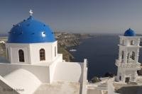 View over a blue Church roof in Oia, Santorini Island in Greece