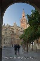 A view of the architecture of the Seville Cathedral and La Giralda from a doorway of the Real Acazar in the City of Sevilla in Andalusia, Spain.