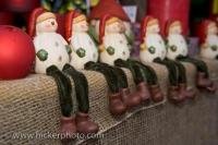 These snowman Christmas decorations hang their floppy legs over the edge of the display at the Hexenagger Castle markets in the town of Hexenagger, Bavaria, Germany. The snowman Christmas decorations are all lined up in a row ready to be taken home.