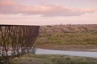 The high level rail bridge crosses the Old Man River on its journey into Lethbridge, Alberta, Canada.