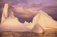 A beautiful pink sunset reflects of this large iceberg in Notre Dame Bay near Twillingate in Newfoundland, Canada.